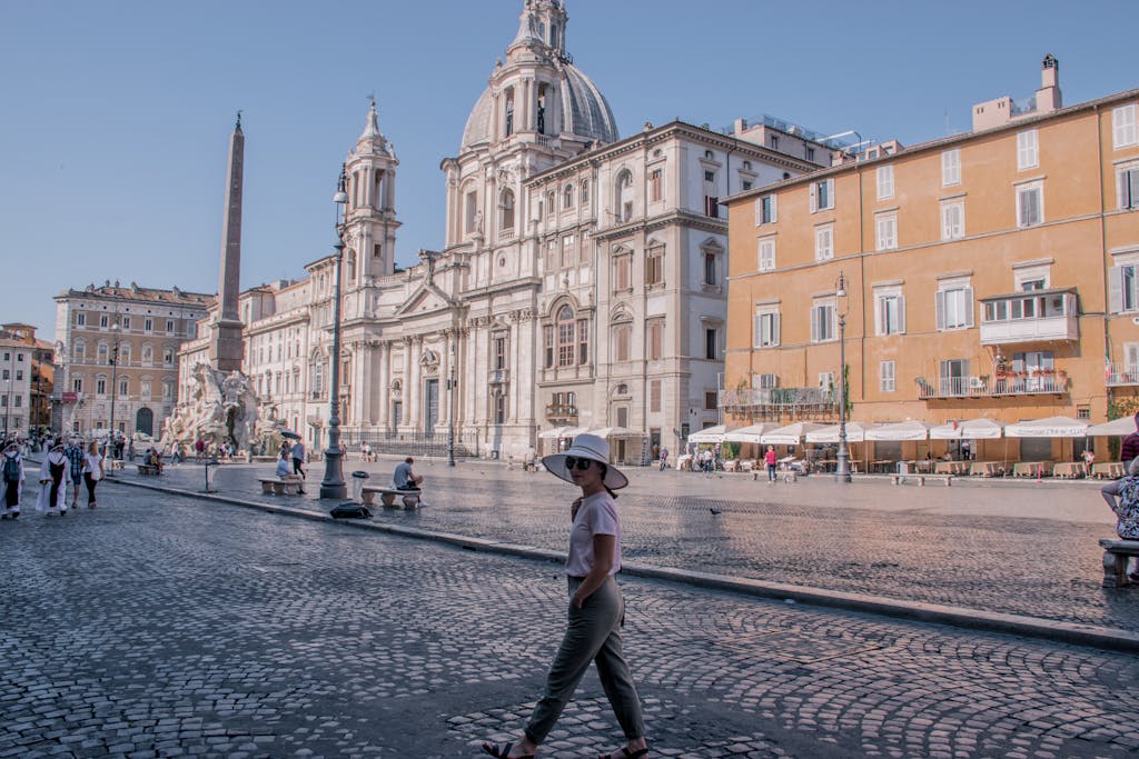 Captivating view of Piazza Navona with tourists enjoying a sunny day in Rome, Italy.