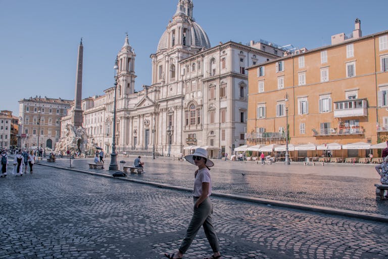 Captivating view of Piazza Navona with tourists enjoying a sunny day in Rome, Italy.