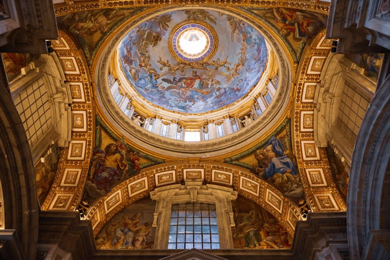 Explore the stunning dome interior of St. Peter's Basilica, Vatican City, showcasing exquisite architectural details.
