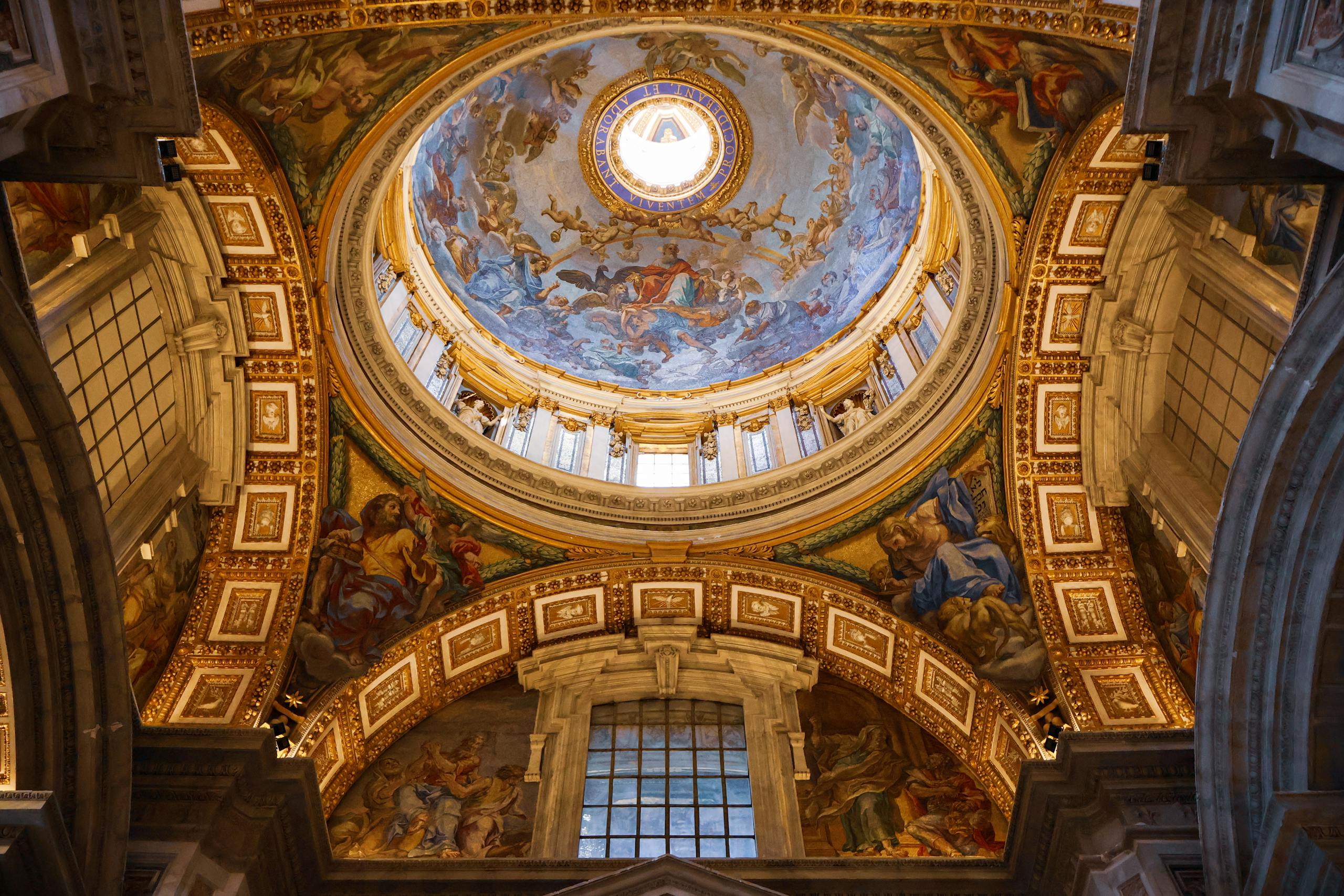 Explore the stunning dome interior of St. Peter's Basilica, Vatican City, showcasing exquisite architectural details.